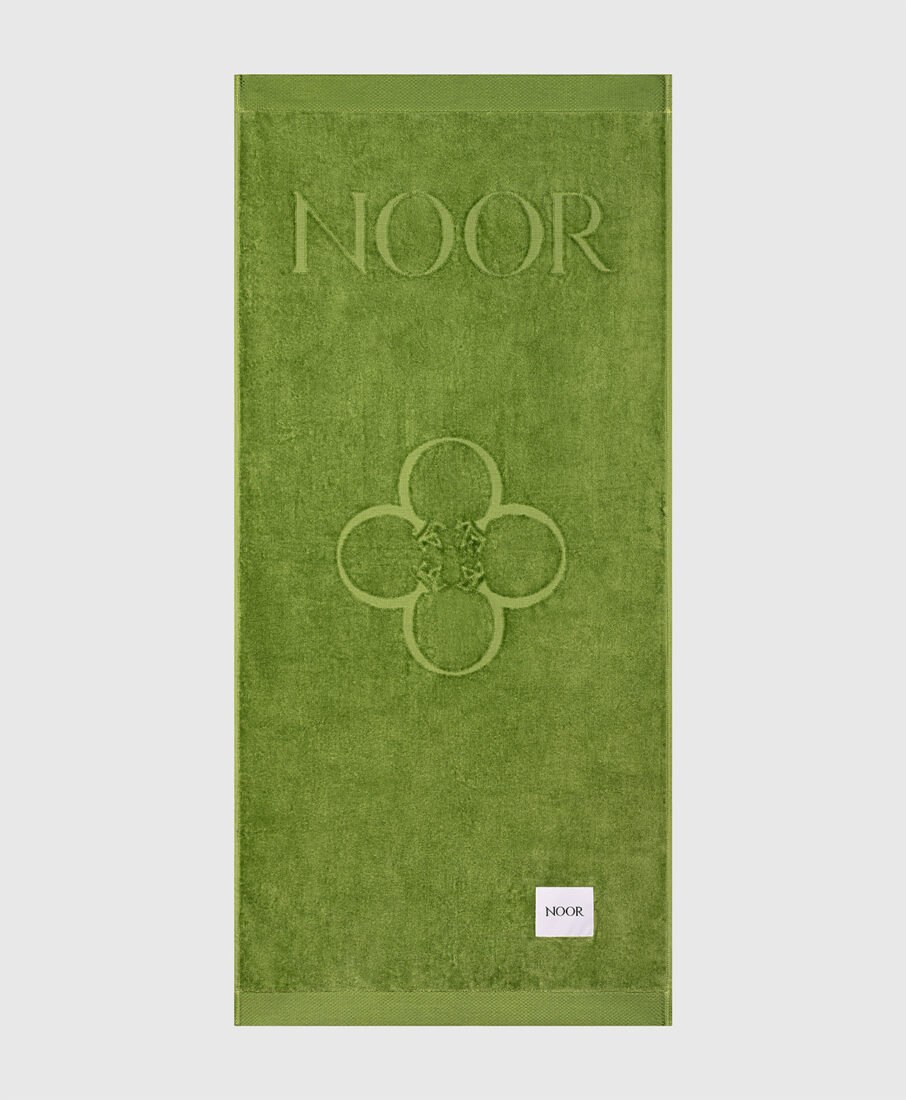 Noor Milano green beach towel, laid out flat, e-commerce product photography by Inlet Studio in Italy.