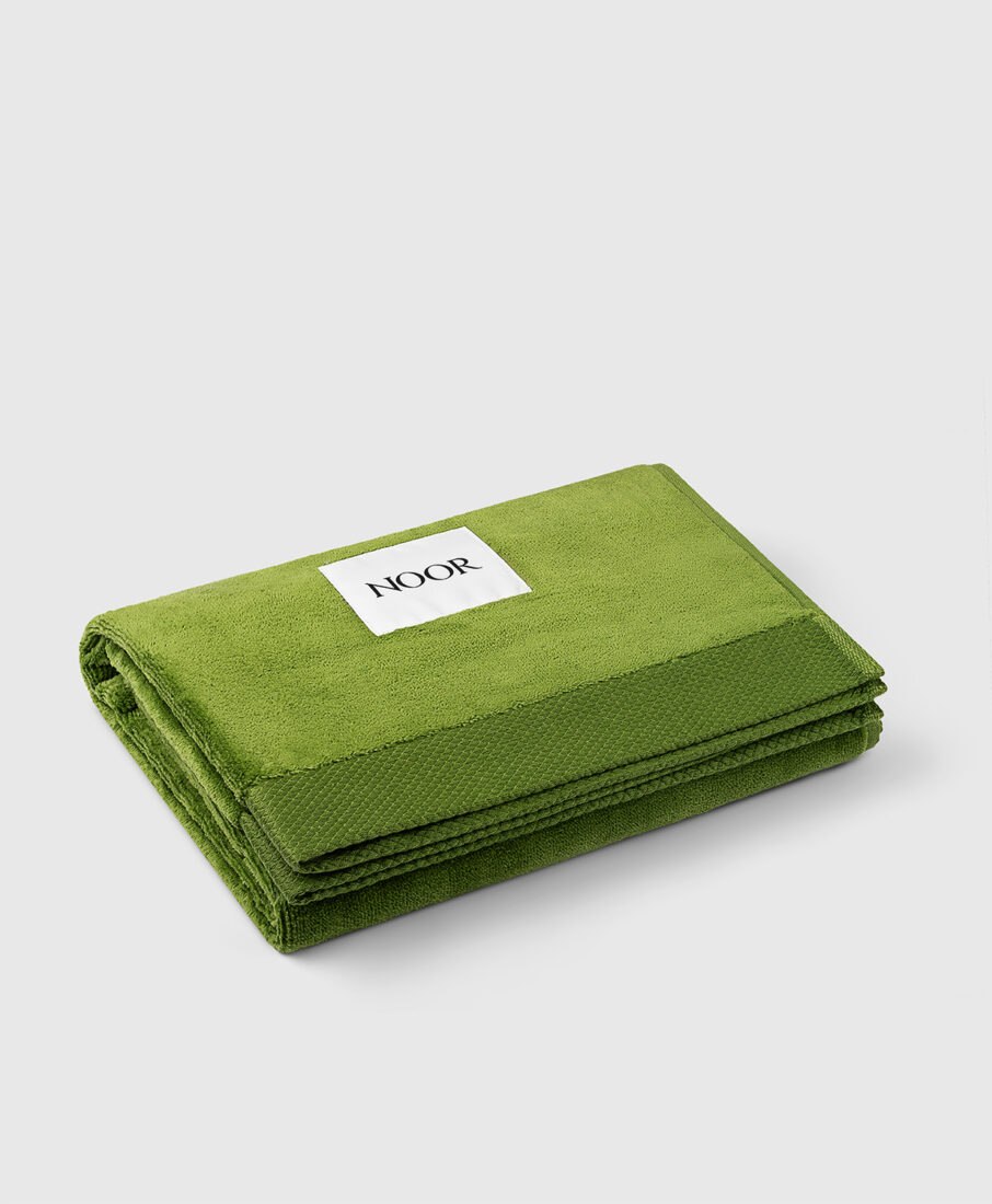 Noor Milano green beach towel, folded view, e-commerce product photography by Inlet Studio in Italy.
