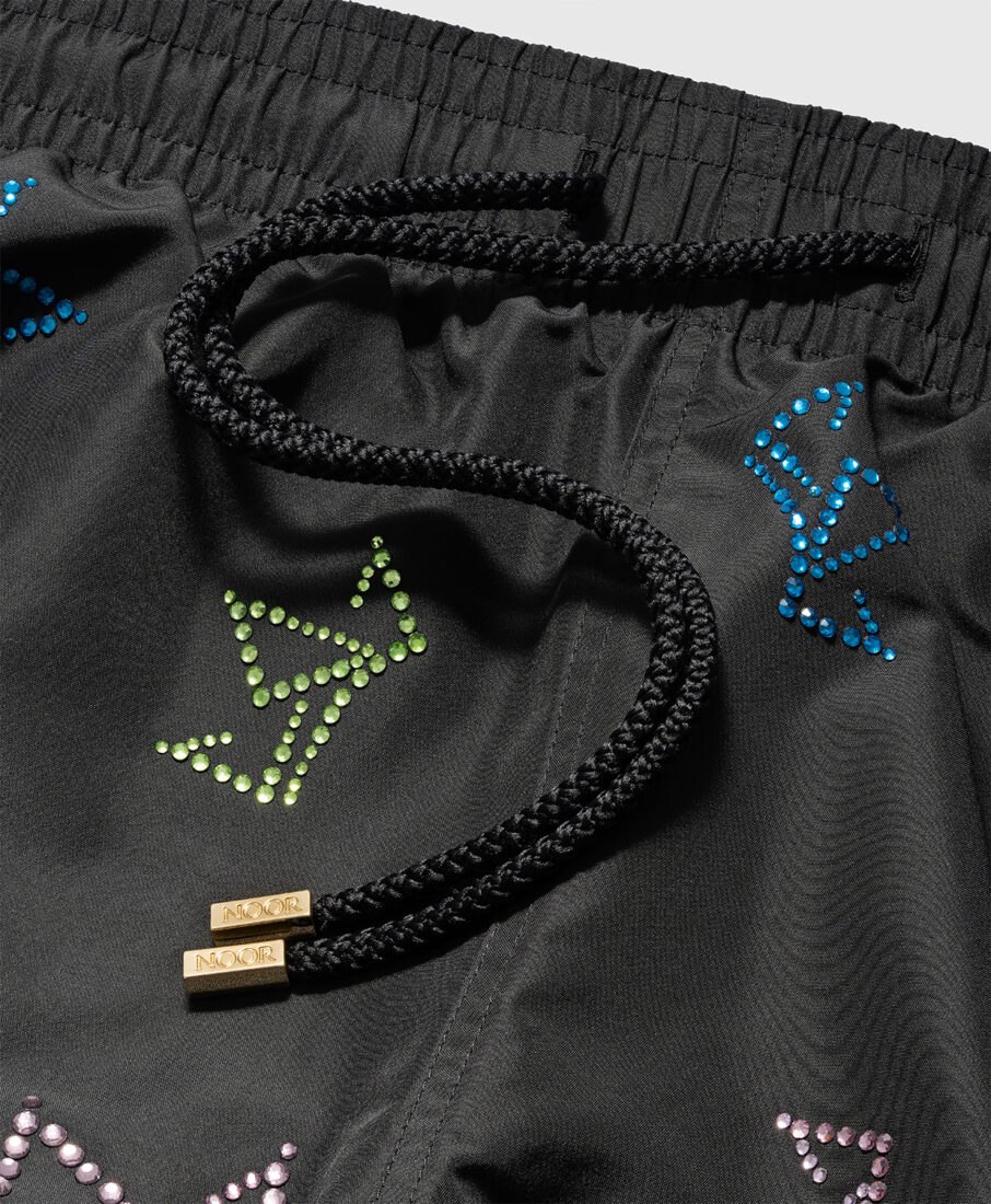 Detail of Noor Milano black swim shorts with colored crystals, professional photography in Italy by Inlet Studio.