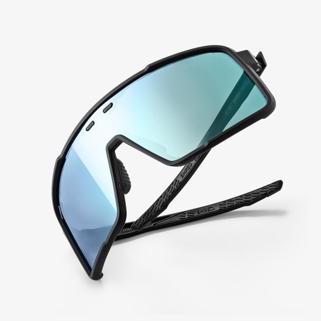 Detail view of Shred sport sunglasses with blue mirrored lenses, professional product photography by Inlet Studio, Italy.