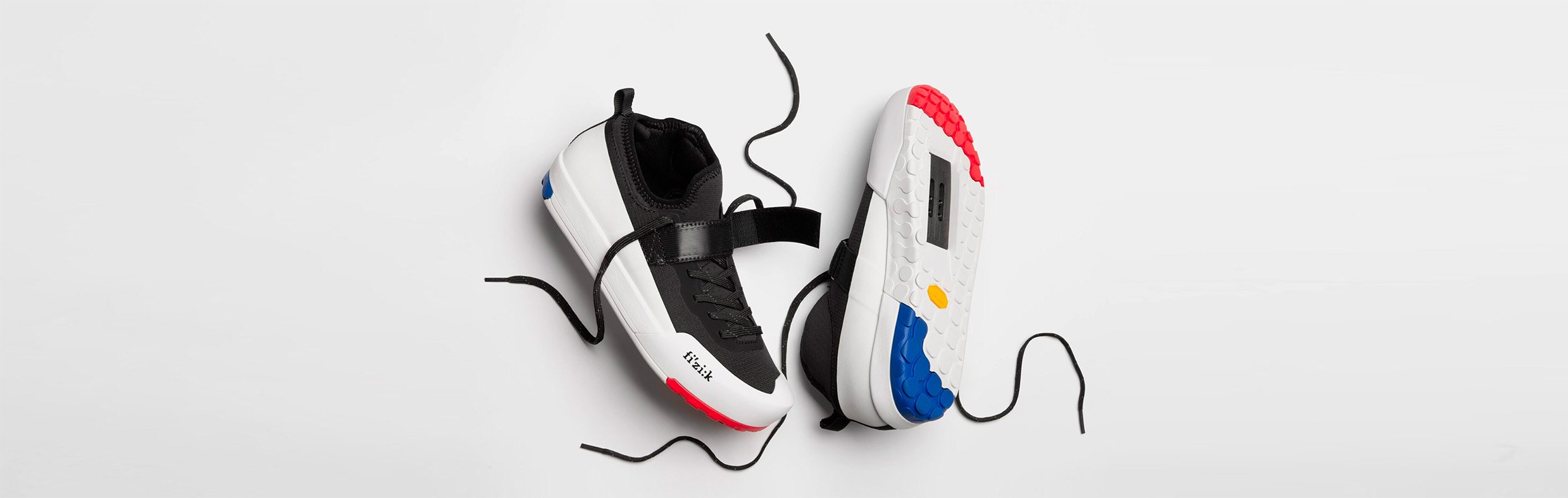 Scarpe da ciclismo Fizik per MTB con attacco SPD, bianche e nere con lacci, servizio professionale realizzato a Vicenza da Inlet Studio.