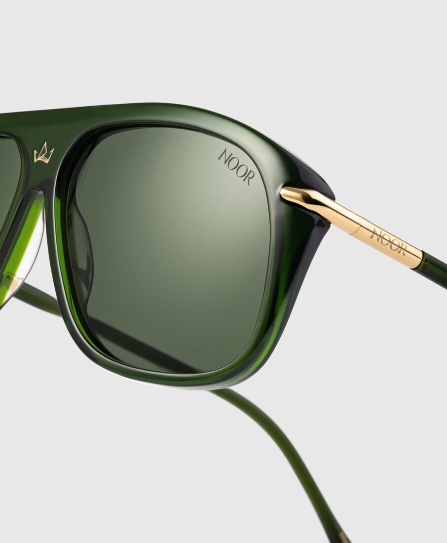 Close-up detail of Noor Milano green sunglasses, gold-plated hardware, luxury product photography by Inlet Studio.
